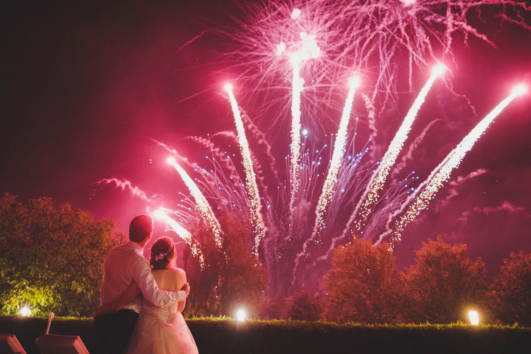 Wedding couple watching a professional firework display